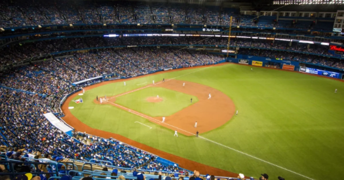 Wide-angle view of a professional baseball stadium with synthetic turf and a packed audience